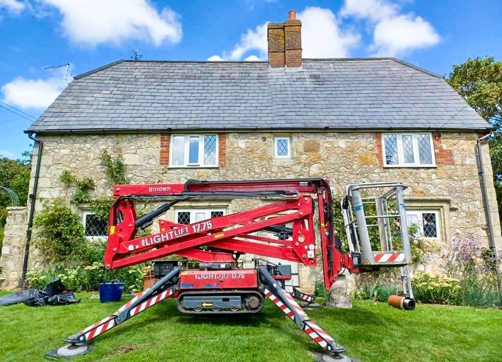 Cherry Picker in front of cottage